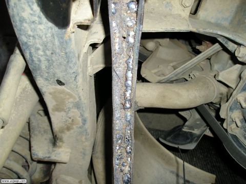 1989 Ford Bronco - Undercarriage view showing a welded bracket and engine components.