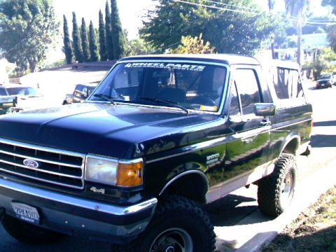 1989 Ford Bronco - This 1989 Ford Bronco is parked on a residential street, showing its 3/4 front profile.