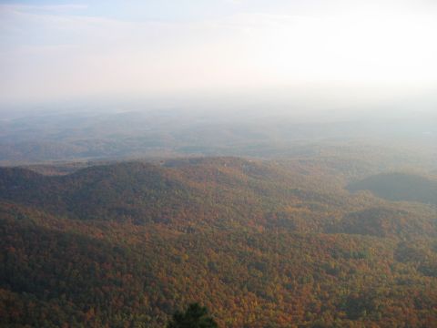 1985 Ford LTD Crown Victoria - A hazy view of rolling hills covered in trees displaying fall colors.
