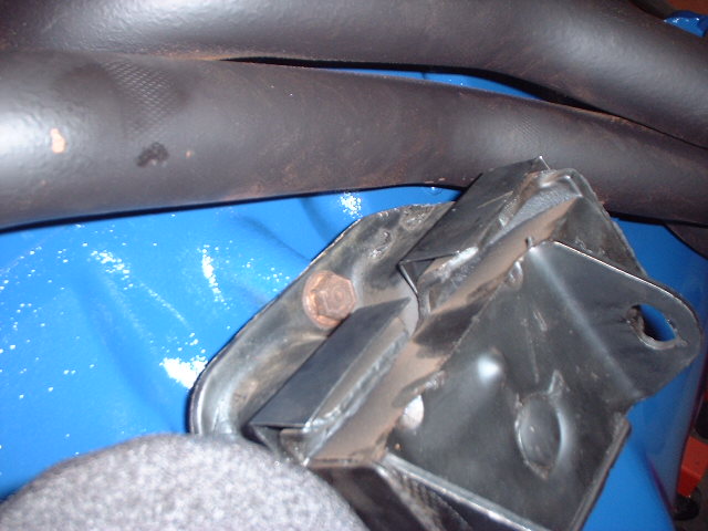 Close-up of black motor mount bracket with bolt on blue-painted chassis area