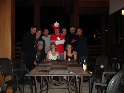 1994 Ford Probe - A group of friends pose for a photo around a table, with one person sporting a festive Canadian-themed hat.