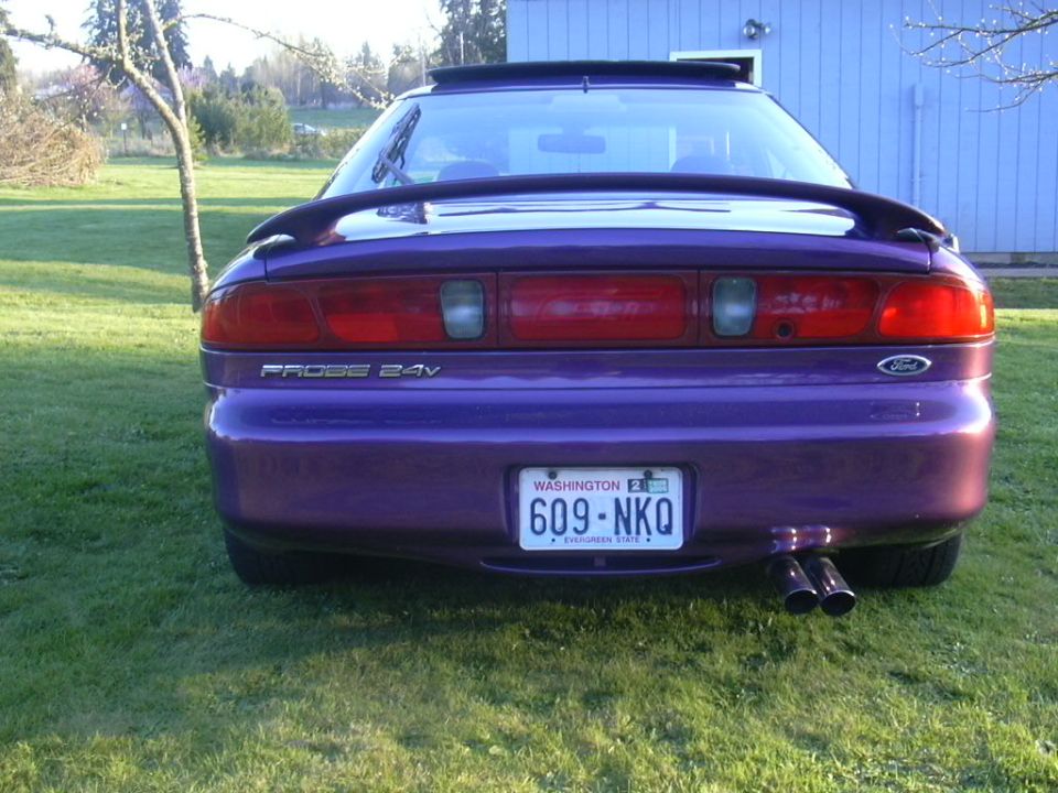 Rear of a purple Ford Probe coupe on grass with Washington plate