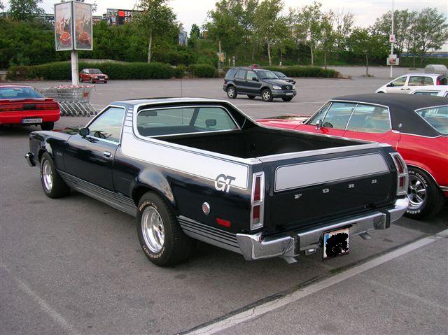 1977 Ford Ranchero GT parked in lot, rear view. Red car and SUV also visible