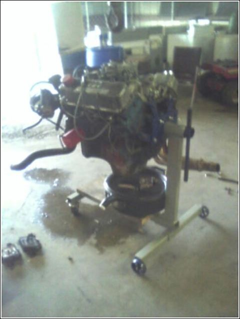1980 Ford Bronco - Engine assembly mounted on a stand, with an oil pan positioned underneath.
