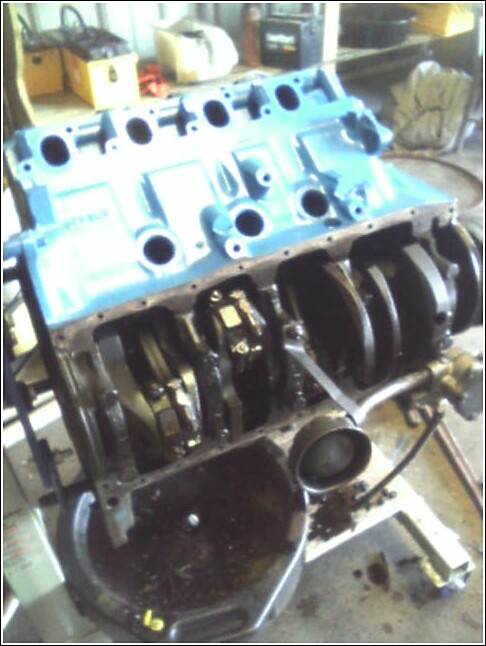 Blue engine block with crankshaft visible