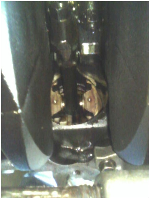 Engine crankshaft and connecting rods with oil pan visible below