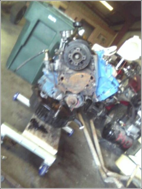 1980 Ford Bronco - An engine is shown on a stand, possibly undergoing maintenance or repair.