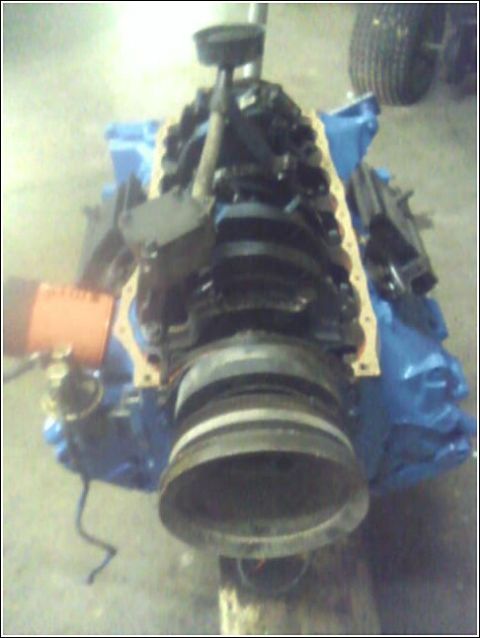 1980 Ford Bronco - Close-up of a vehicle engine with the crankshaft and oil filter visible.