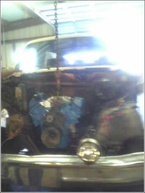 1980 Ford Bronco - Engine being lowered into the engine bay of a 1980 Ford Bronco.