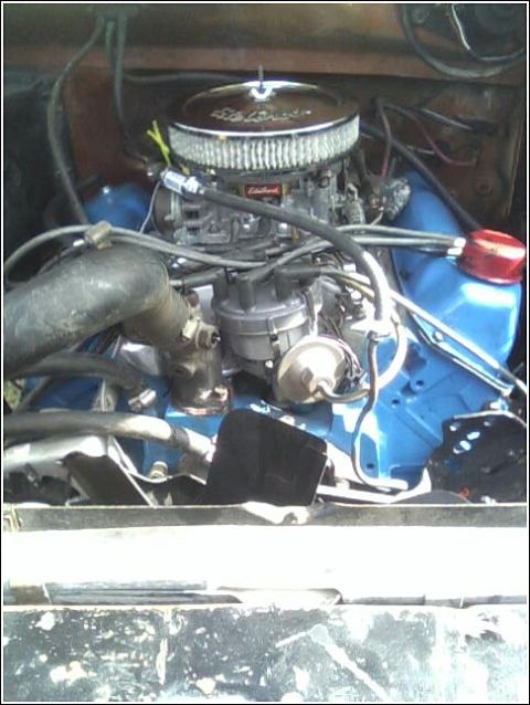 1980 Ford Bronco - Overhead view of a Ford-blue painted V8 in a truck engine bay, fitted with an Edelbrock four-barrel carburetor and chrome-lid air cleaner o…