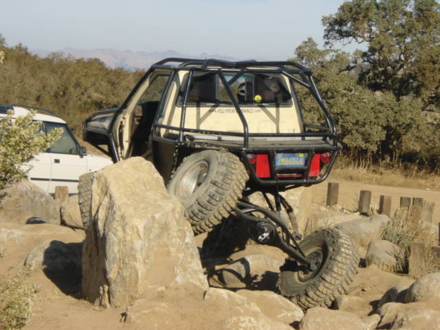 Off-road vehicle with roll cage on rocks, rear view. License plate 2MB606