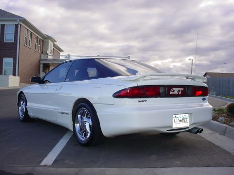 1996 Ford Probe - Rear view of a white 1996 Ford Probe GT with a spoiler and dual exhaust pipes.