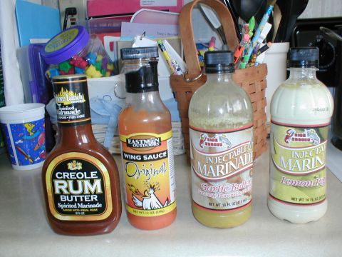 1979 Ford Bronco - A collection of marinades and wing sauce bottles are arranged on a kitchen counter.
