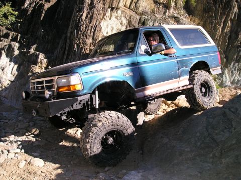 1993 Ford Bronco - This 1993 Ford Bronco navigates a challenging rocky trail with a driver behind the wheel.