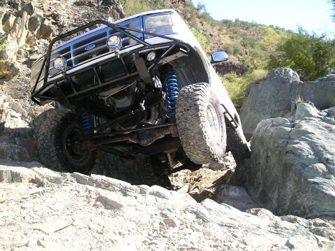 1993 Ford Bronco - This modified Ford Bronco navigates a challenging rocky terrain, its off-road capabilities.