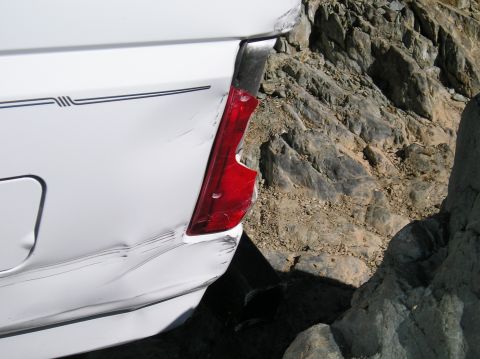 1993 Ford Bronco - This 1993 Ford Bronco shows significant damage to its rear quarter panel and taillight, likely from off-road use.