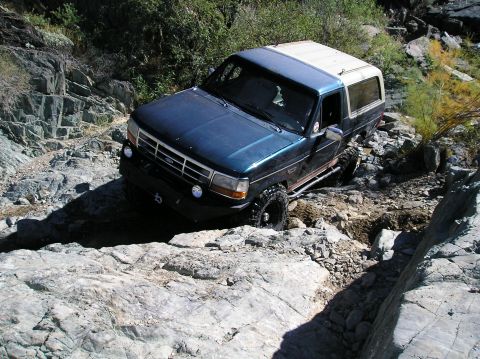1993 Ford Bronco - This Ford Bronco is tackling a challenging rocky terrain, its off-road capabilities.