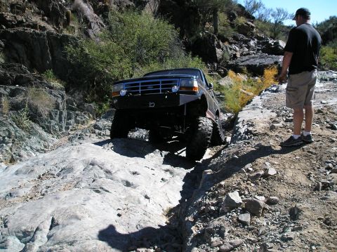 1993 Ford Bronco - Ford Bronco tackling a difficult rocky off-road path.