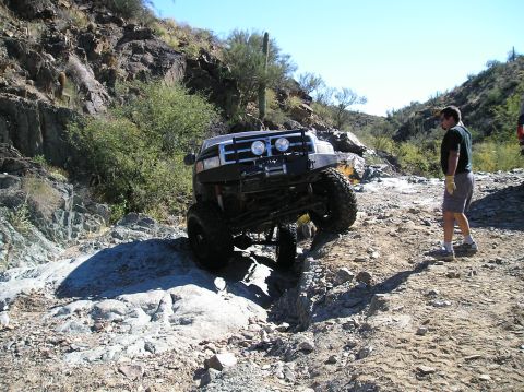 1993 Ford Bronco - A modified SUV tackles a challenging off-road course in a desert environment.