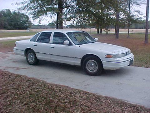 1993 Ford Crown Victoria - This sedan is parked outdoors on a paved surface with trees and grass visible.