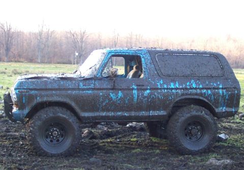 1978 Ford Bronco - Muddy 1978 Ford Bronco sits in a field after off-roading.
