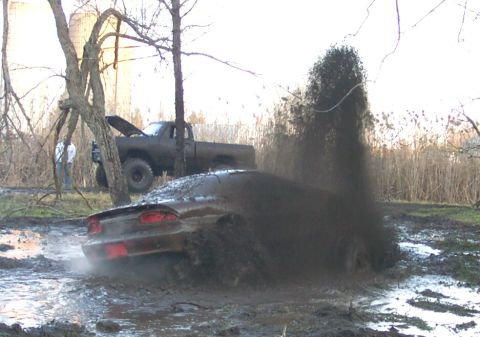 1978 Ford Bronco - A fourth-generation Chevrolet Camaro coupe buries itself in a mud pit, throwing a tall plume of mud over the roofline as its rear tires spi…