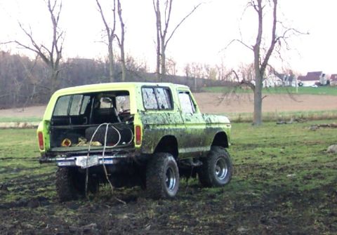 1978 Ford Bronco - This heavily modified 1978 Ford Bronco is shown off-road in a muddy field.