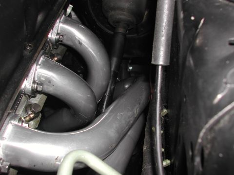 1993 Ford Thunderbird - Exhaust manifold pipes and steering linkage visible in engine bay.