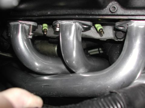 1993 Ford Thunderbird - The image shows an engine's exhaust manifold and spark plugs, not a 1993 Ford Thunderbird.