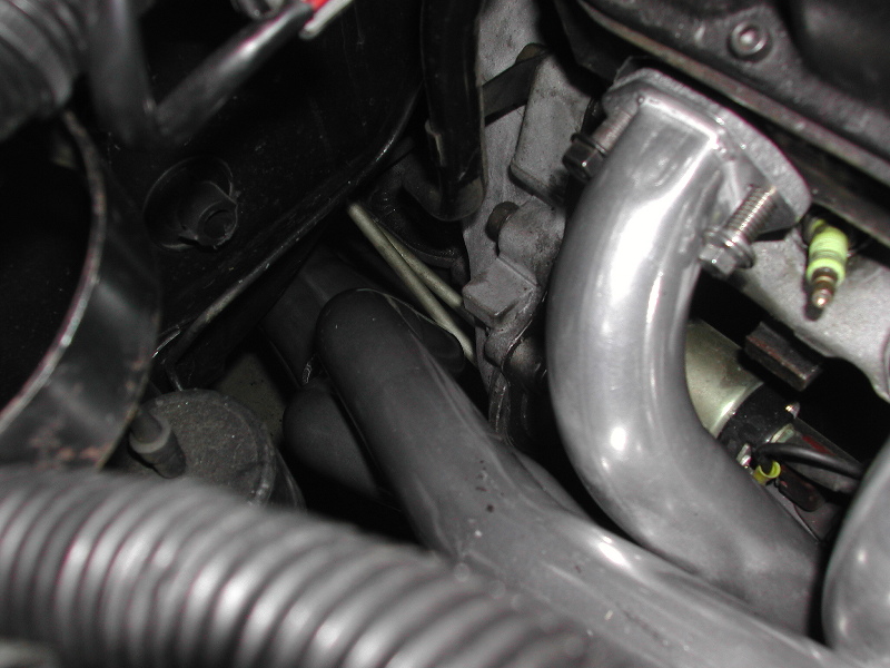 Close-up of an engine's exhaust manifold and spark plug