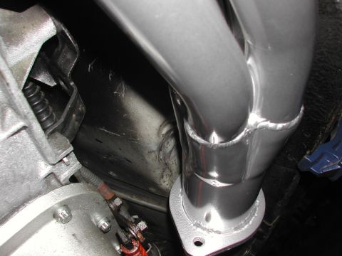 1993 Ford Thunderbird - Close-up view of a vehicle's exhaust manifold and engine components.