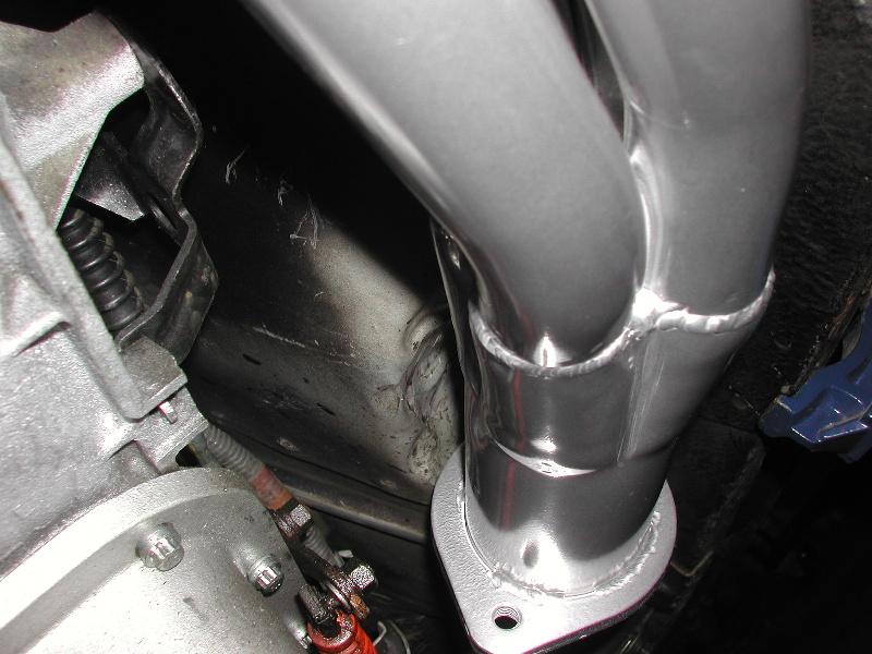 Exhaust manifold pipes with a flange, attached to a vehicle's engine block