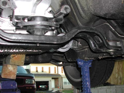 1993 Ford Thunderbird - The underside of a vehicle is shown, with a residential scene in the background.