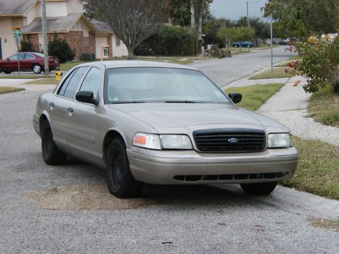 1999 Ford Crown Victoria - This Ford Crown Victoria is parked on a residential street, showing its front end.
