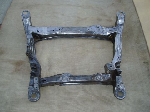 1993 Ford Taurus - A bare metal subframe, likely for a car, is shown against a neutral background.