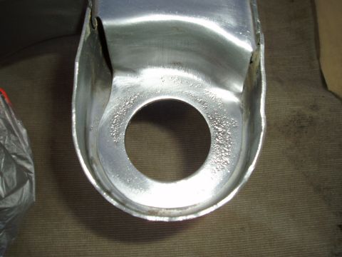 1993 Ford Taurus - Close-up of a metal subframe component, showing wear and corrosion around a central hole.
