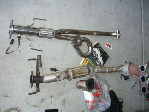 1996 Ford Probe - Two exhaust system assemblies, possibly for a car, are shown on a concrete surface.