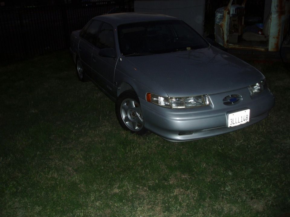 Silver 1993 Ford Taurus parked on grass
