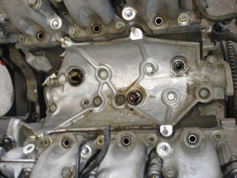 1993 Mazda MX-3 - This is a close-up view of an engine's intake manifold, showing wear and tear.