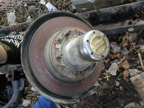 1979 Ford Bronco - A close-up of a rusty front wheel hub assembly, likely from an older vehicle, with a visible brake rotor.