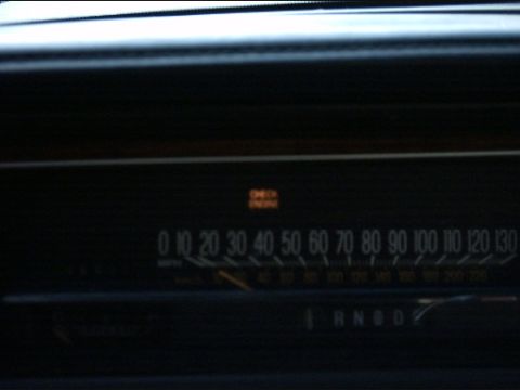 1991 Ford LTD Crown Victoria - The dashboard displays a speedometer and an illuminated check engine light, indicating a potential issue.