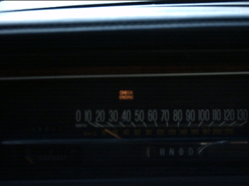 Dashboard interior with speedometer and illuminated check engine light