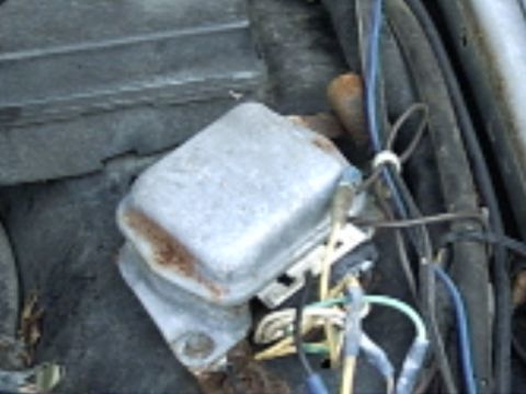 1991 Ford LTD Crown Victoria - This image shows a close-up of a vehicle's voltage regulator and associated wiring.