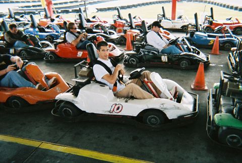 1991 Ford Probe - Go-karts are parked in a line, ready for drivers at an amusement park or track.