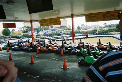 1991 Ford Probe - A fleet of go-karts are parked in a row, ready for racing on a sunny day.