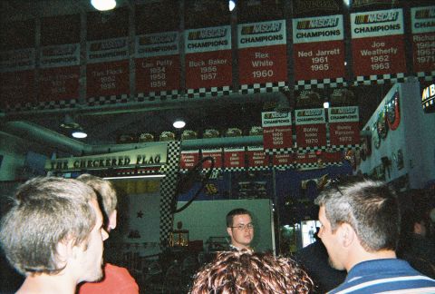 1991 Ford Probe - Banners celebrating NASCAR champions are displayed in a room with checkered flag accents.