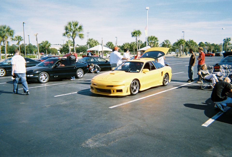 Yellow sports car with aftermarket body kit and trunk open