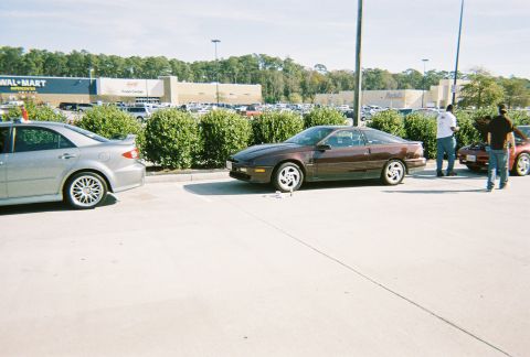 1991 Ford Probe - A maroon 1991 Ford Probe is seen from the front-three-quarter view in a parking lot.