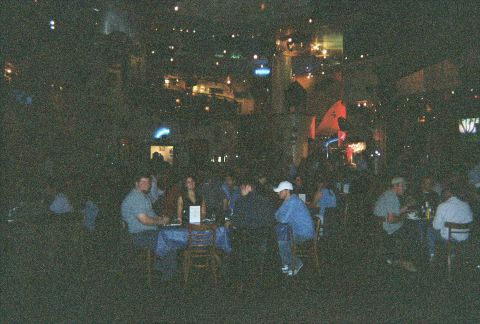 1991 Ford Probe - A dimly lit scene shows people gathered at tables inside a restaurant or bar.