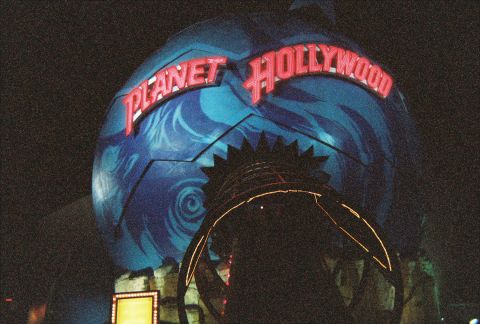 1991 Ford Probe - The iconic Planet Hollywood globe entrance is illuminated at night, its distinctive architecture and signage.
